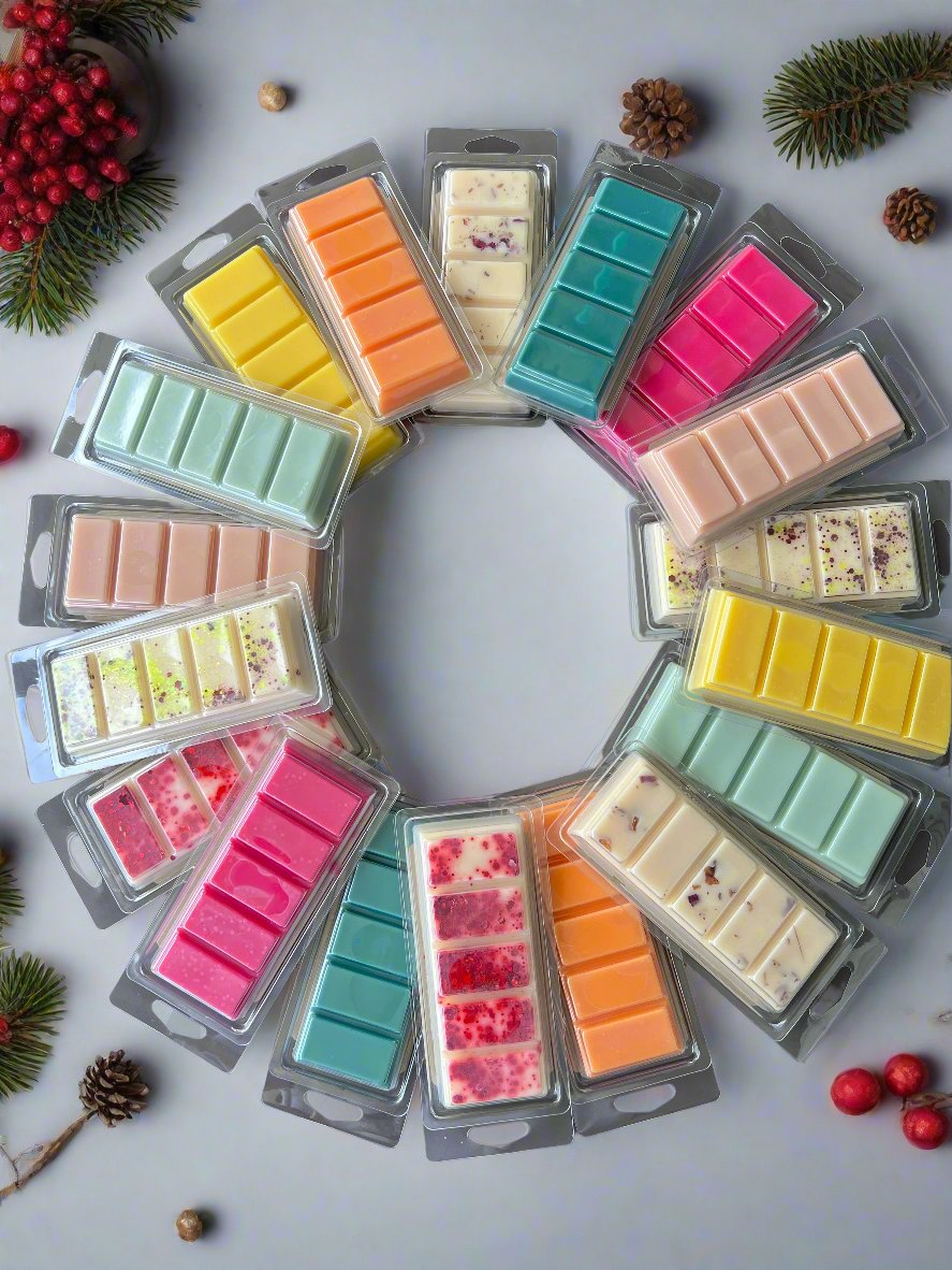 Colorful assortment of Garden Wick soy wax melt bars arranged in a circle, showcasing the variety of clean, hand-poured fragrances available year-round and seasonally.