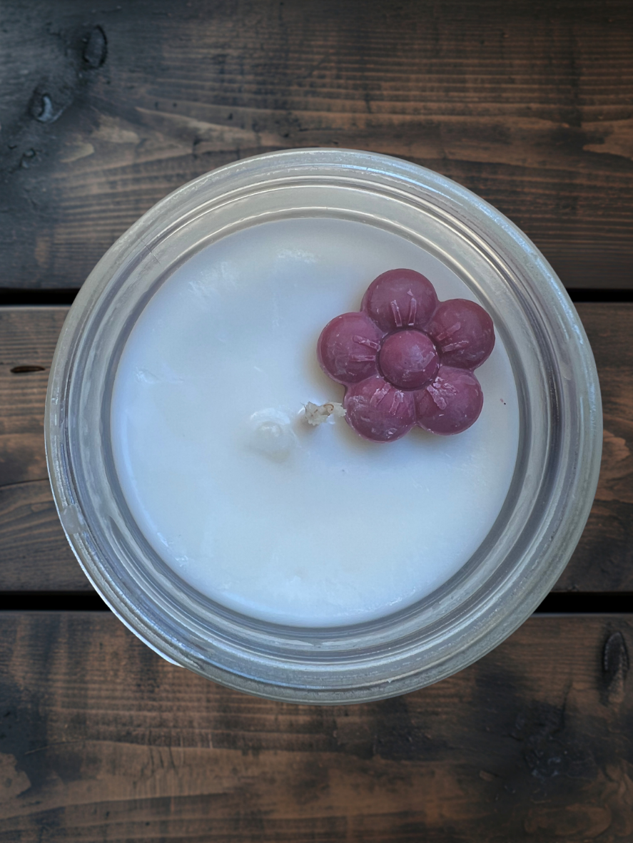 Wildflower Glow soy candle by Garden Wick Candle Company with soft floral notes of orange blossom and rose layered with honey, amber, musk, and cedar, inspired by an open meadow in bloom.