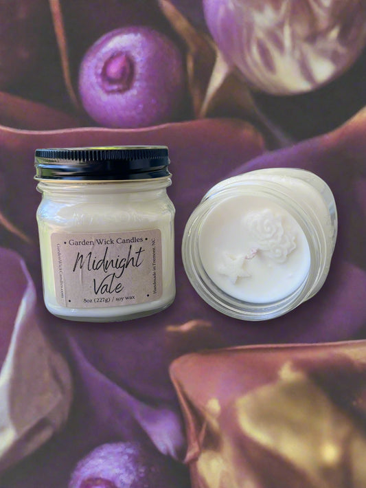 Midnight Vale mason jar candle with dark, floral and fruity fragrance featuring bergamot, geranium, violet, raspberry, saffron, leather, and vetiver from Garden Wick