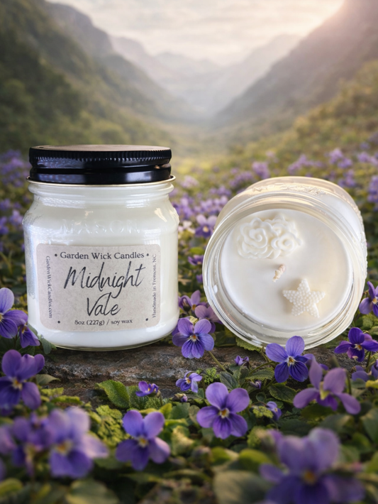 Midnight Vale mason jar candle with dark, floral and fruity fragrance featuring bergamot, geranium, violet, raspberry, saffron, leather, and vetiver from Garden Wick