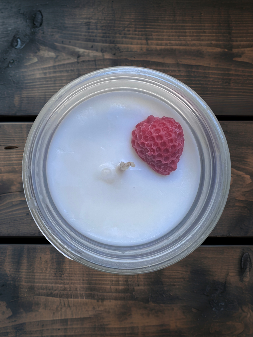 Strawberry Fields mason jar soy candle with a strawberry-forward scent blending ripe strawberry, tropical passion fruit, guava, sugar, vanilla, and cream.