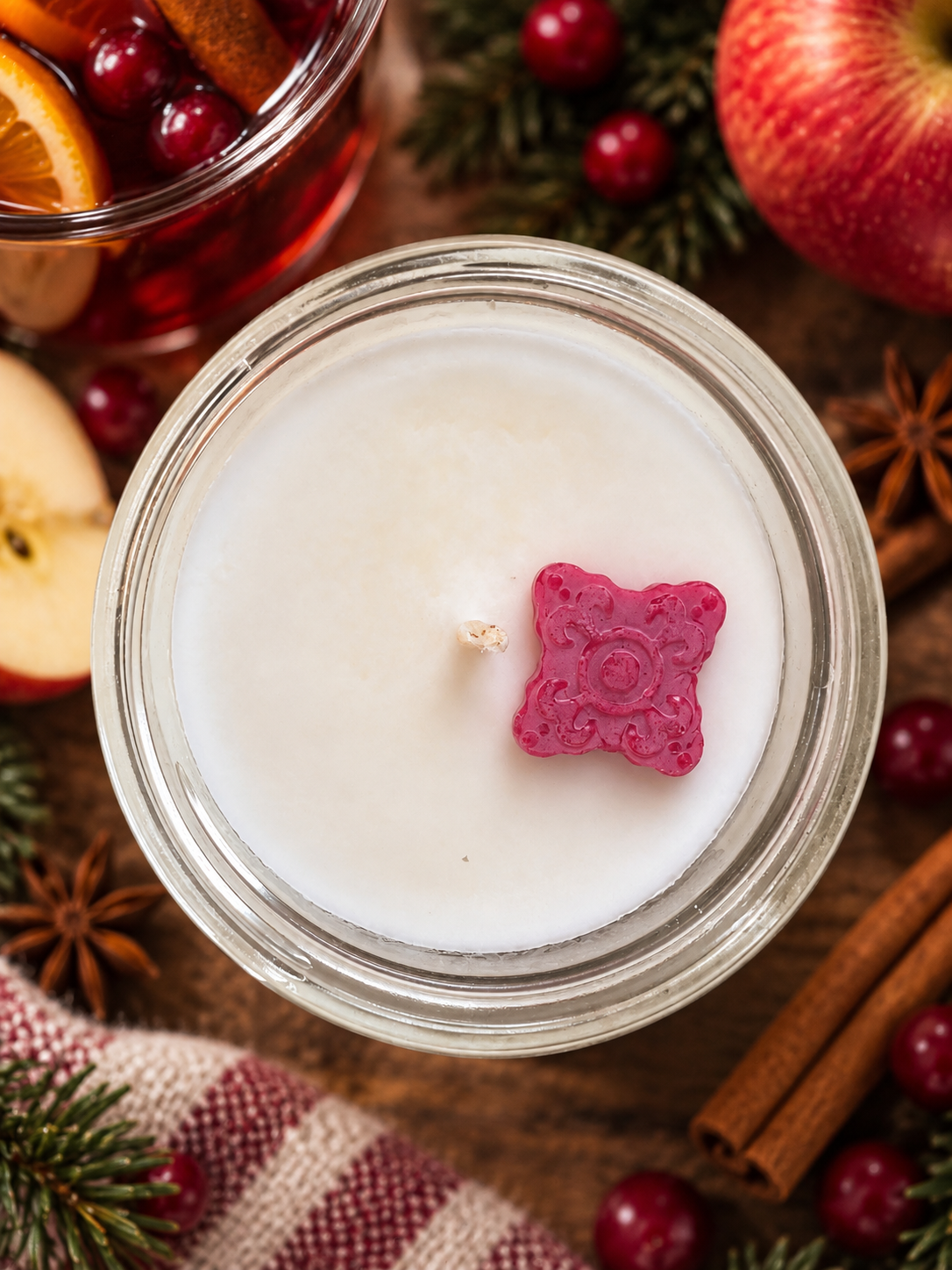 Top view of Garden Wick Wassail soy candle featuring a decorative wax embed and warm holiday fragrance.