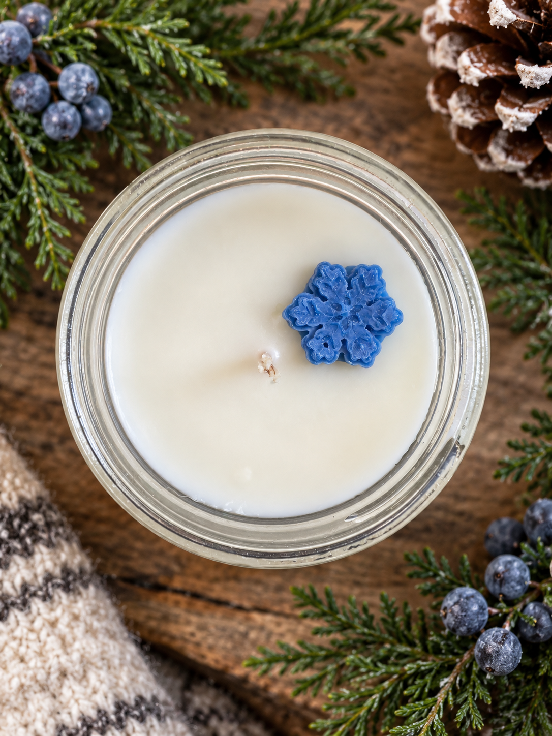 Top view of Garden Wick Winter Woods soy candle featuring a decorative snowflake wax embed.